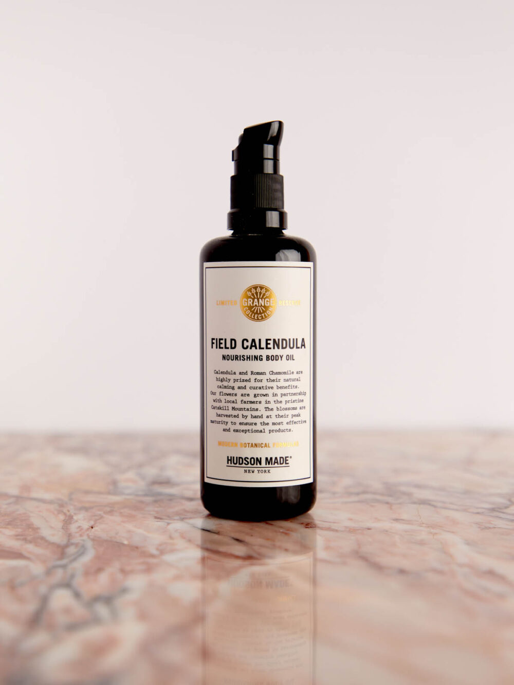 Field Calendula - Nourishing Body Oil on pink marble by Hudson Made