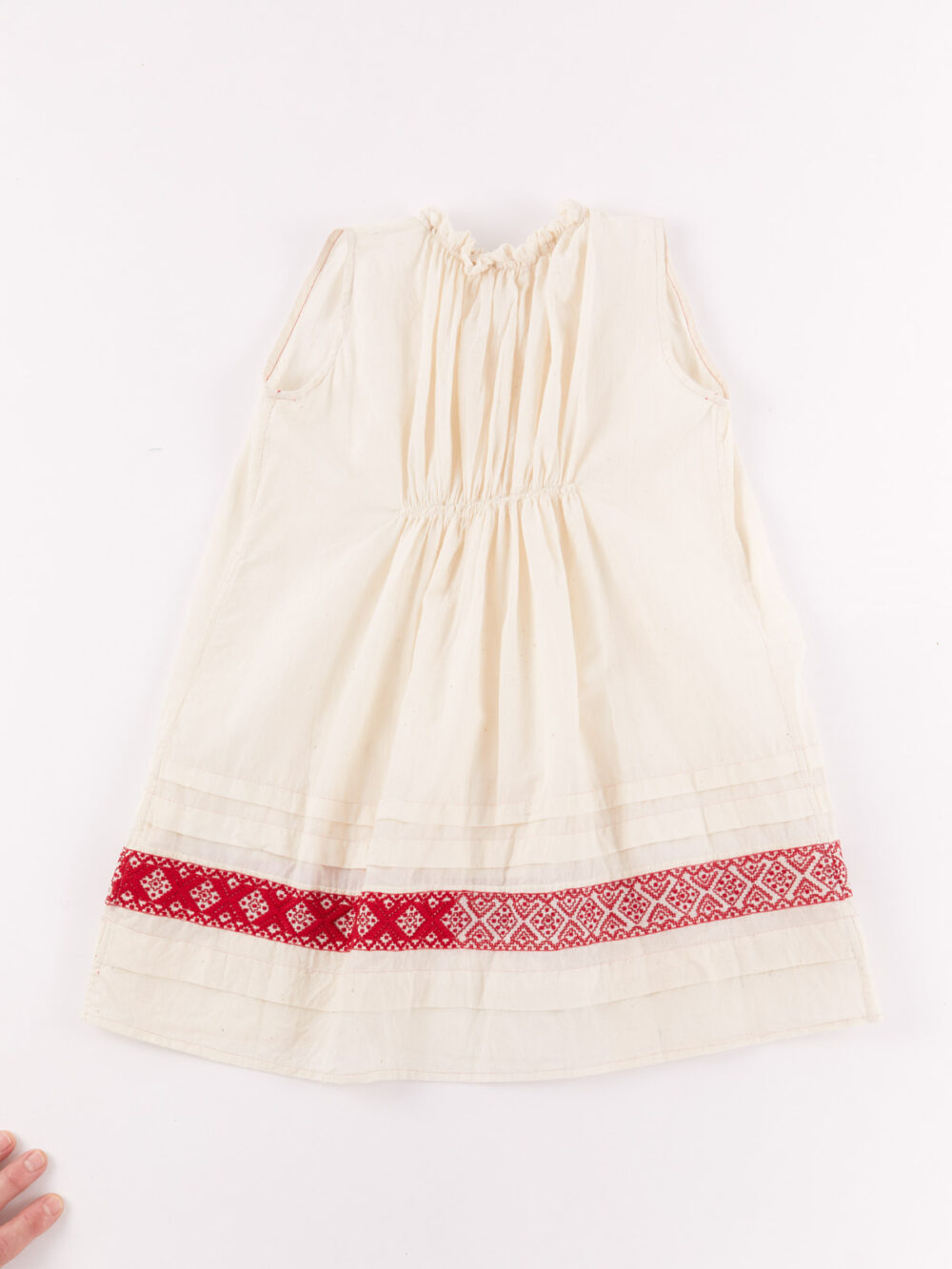 injiri sleeveless baby dress in ivory with red trim back