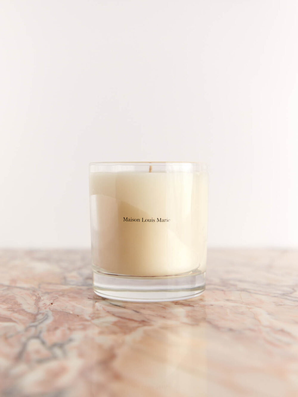 No. 04 Bois de Balincourt Candle by Maison Louis Marie on pink marble
