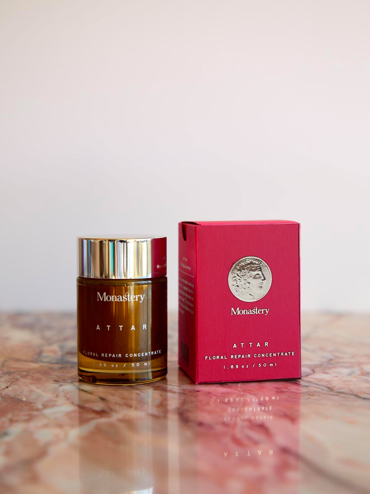 Monastery Attar floral concentrate and box on a marble surface