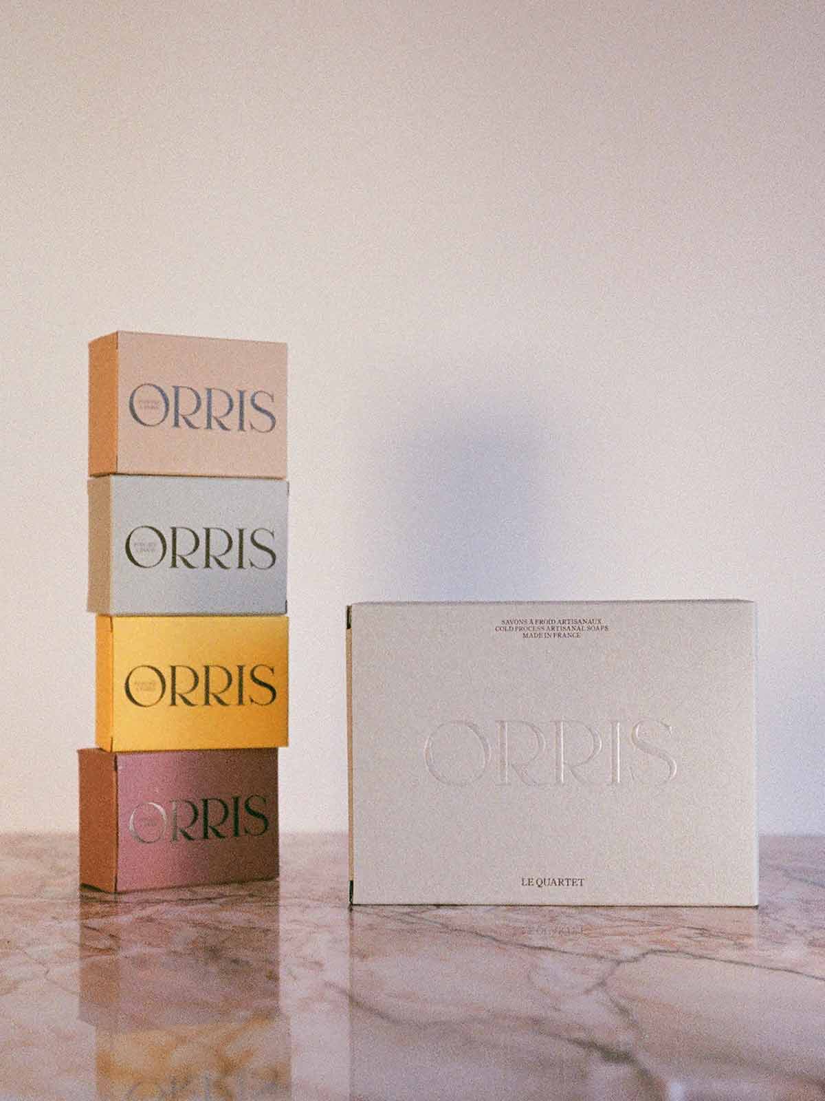 Orris le quartet box of 4 soaps on pink marble and 4 soap boxes stacked