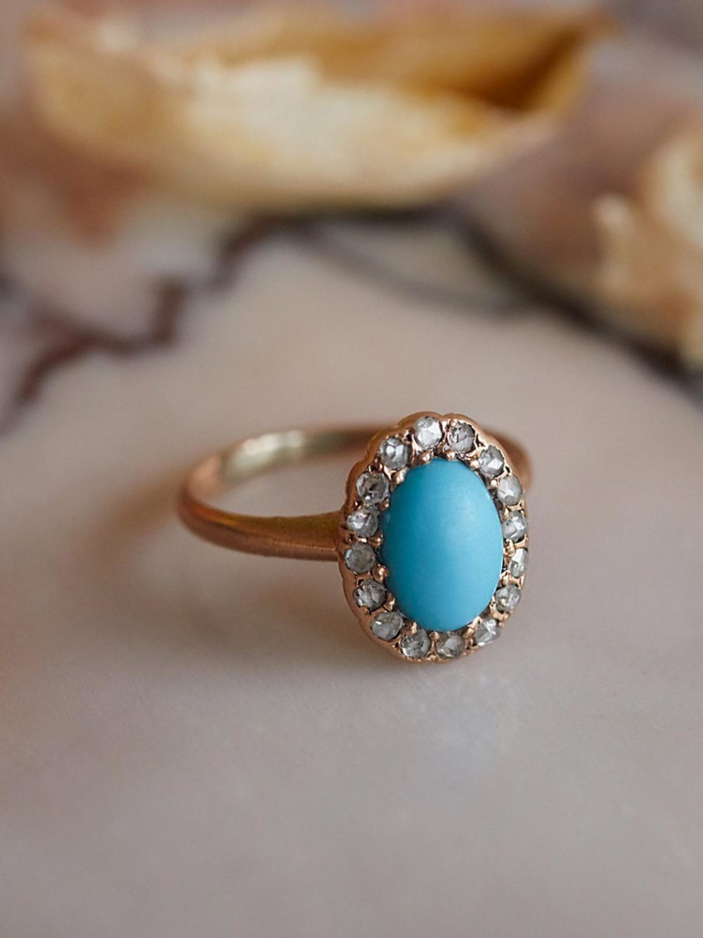 turquoise ring with diamonds on table