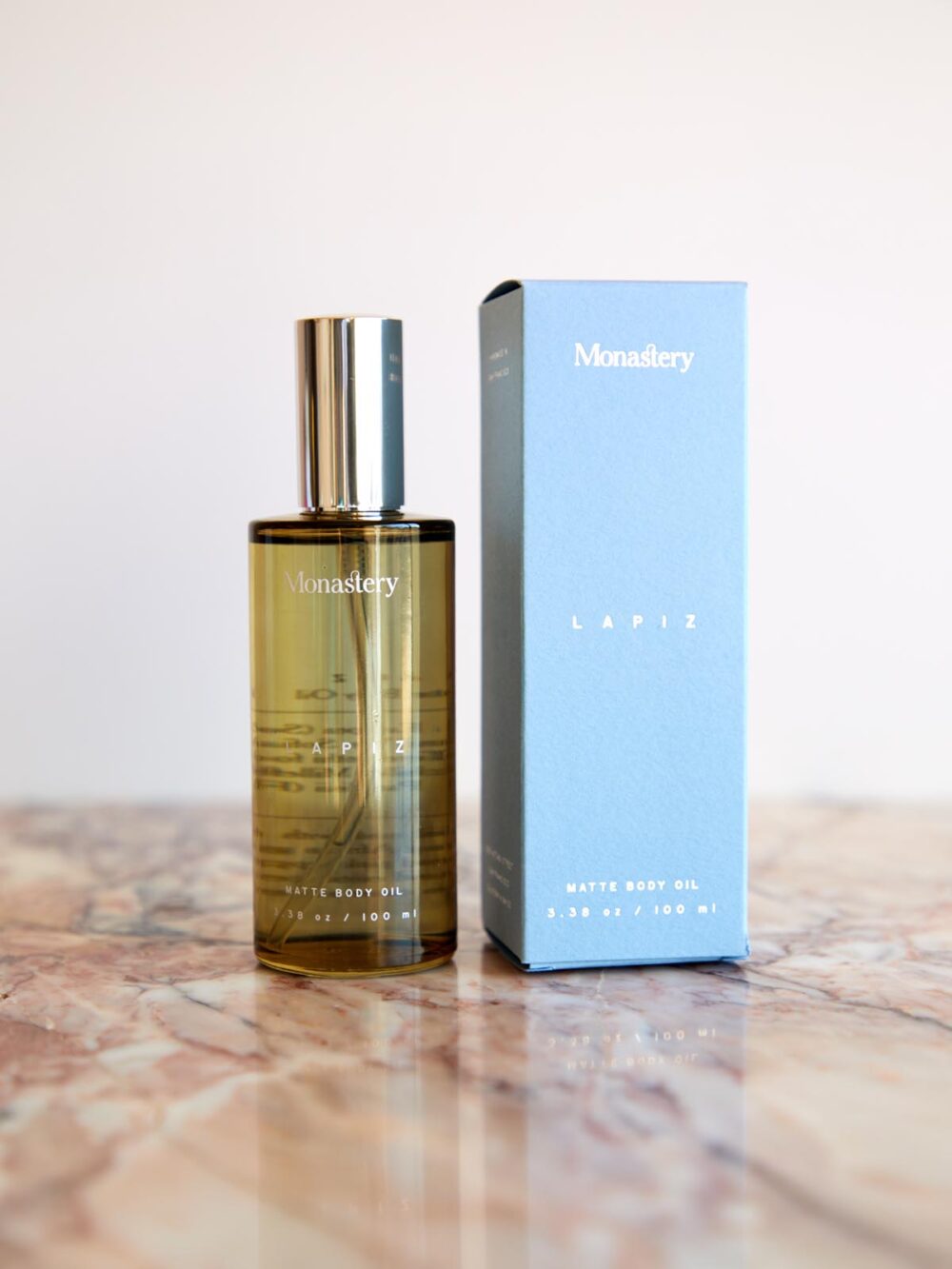 Lapiz Matte Body Oil and box on pink marble by Monastery Made