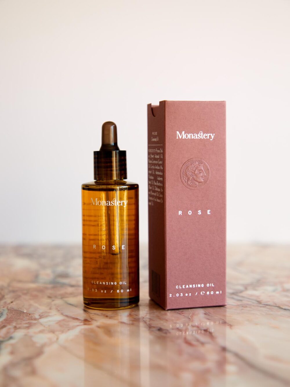 Rose Cleansing Oil with box on pink marble